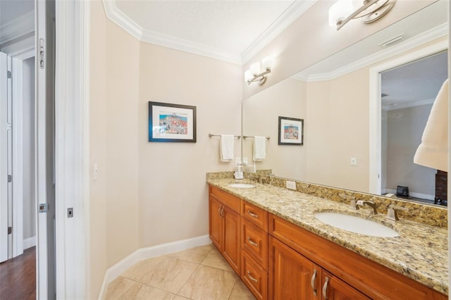full bathroom with double vanity, ornamental molding, baseboards, and tile patterned floors