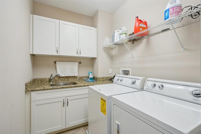 washroom featuring independent washer and dryer and cabinet space