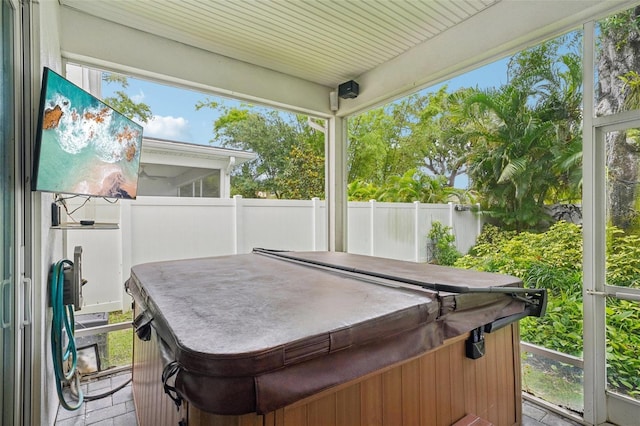 sunroom / solarium with a jacuzzi and healthy amount of natural light