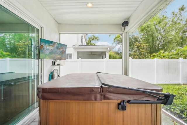 sunroom / solarium featuring a jacuzzi