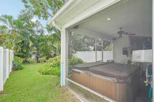 view of yard featuring a hot tub and ceiling fan