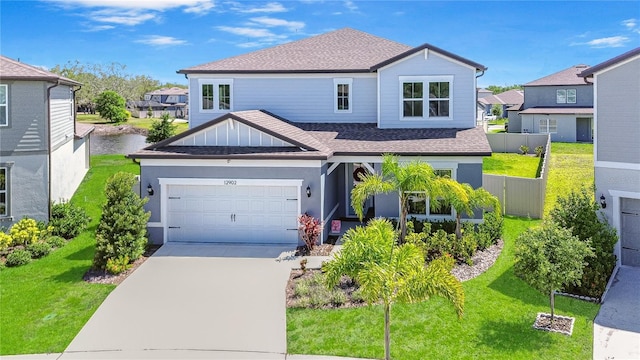 traditional-style home with a shingled roof, concrete driveway, and a residential view