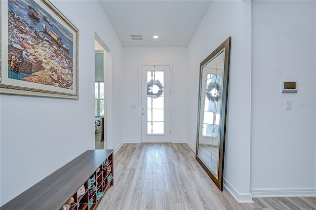 foyer entrance featuring light wood-type flooring and baseboards