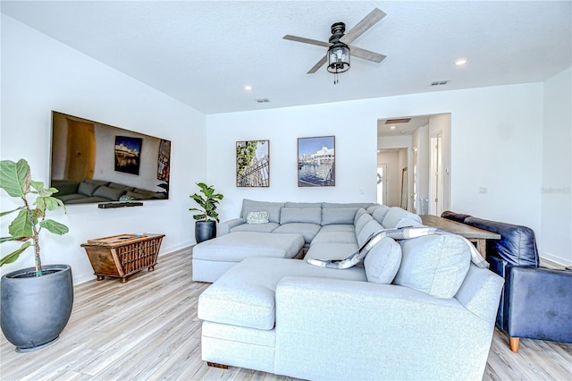 living area with light wood-style floors, ceiling fan, baseboards, and recessed lighting