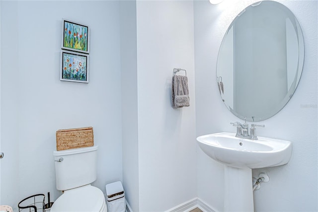 half bathroom with toilet and a sink