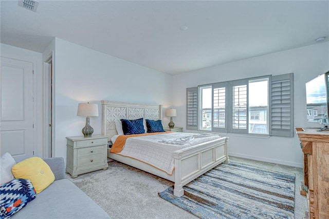 bedroom featuring light colored carpet and baseboards