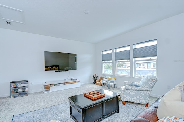 carpeted living area with baseboards
