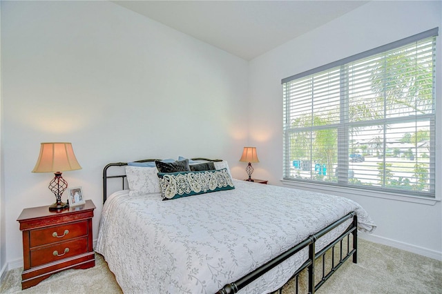 carpeted bedroom with baseboards