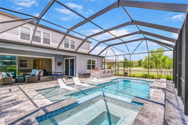 view of pool featuring a patio, an outdoor hangout area, a pool with connected hot tub, glass enclosure, and fence