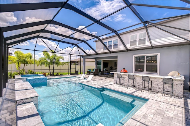 view of pool with a patio, a lanai, and a pool with connected hot tub