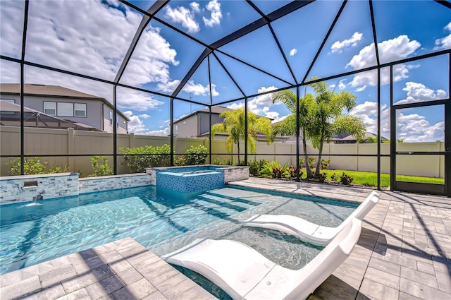 view of pool with a lanai, a pool with connected hot tub, a patio, and a fenced backyard