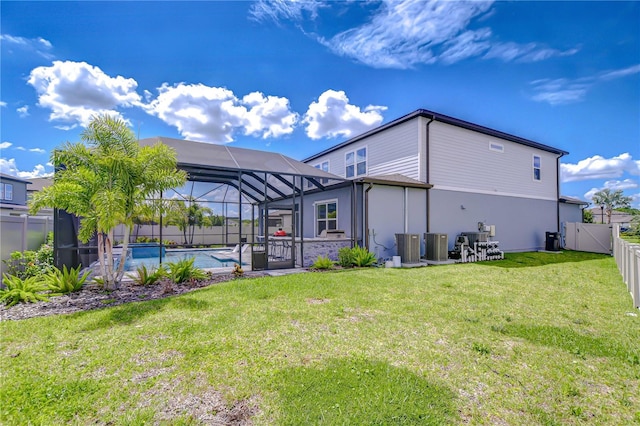 back of property with glass enclosure, cooling unit, a patio area, stucco siding, and a gate
