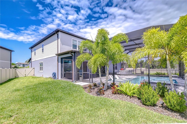 rear view of property featuring a gate, a patio, and stucco siding