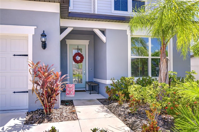 entrance to property featuring stucco siding
