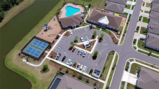 aerial overview of property's location featuring a pool and a nearby body of water