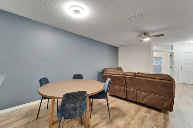 15855 Fishhawk View Dr, Lithia, FL 33547 - dining area with light wood-type flooring, ceiling fan, a textured ceiling, and baseboards