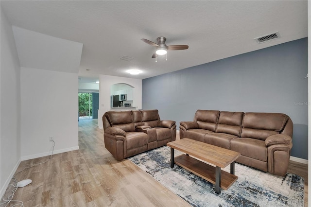 15855 Fishhawk View Dr, Lithia, FL 33547 - living area with wood finished floors, a ceiling fan, baseboards, and arched walkways