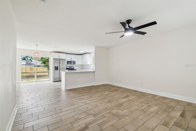 1801 E Navajo Ave, Tampa, FL 33612 - unfurnished living room with ceiling fan, wood finish floors, and baseboards