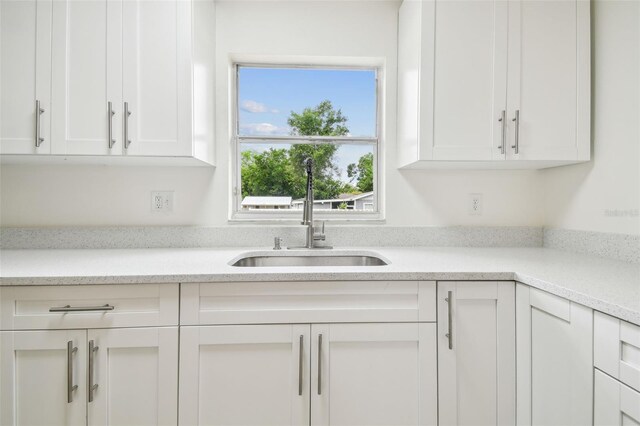1801 E Navajo Ave, Tampa, FL 33612 - kitchen featuring a sink and white cabinetry