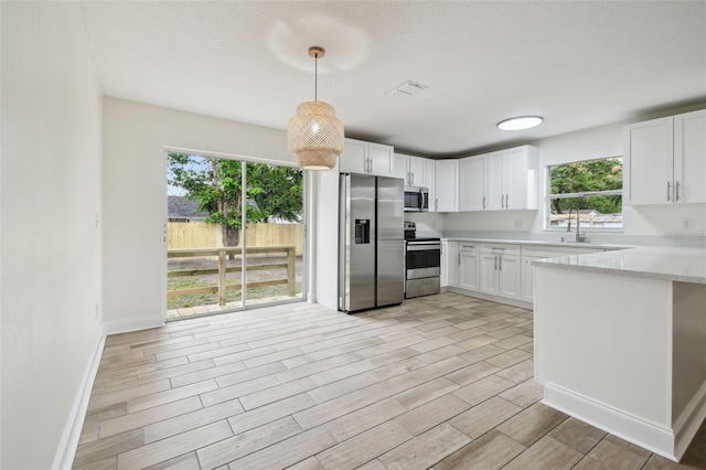 1801 E Navajo Ave, Tampa, FL 33612 - kitchen with appliances with stainless steel finishes, light wood-type flooring, and white cabinetry