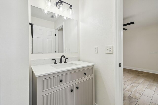 1801 E Navajo Ave, Tampa, FL 33612 - bathroom with vanity, wood finished floors, and baseboards