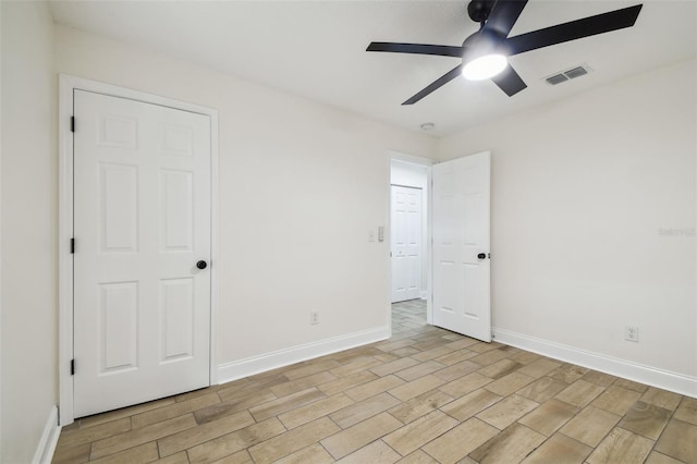 1801 E Navajo Ave, Tampa, FL 33612 - unfurnished bedroom with wood finish floors, baseboards, and a ceiling fan