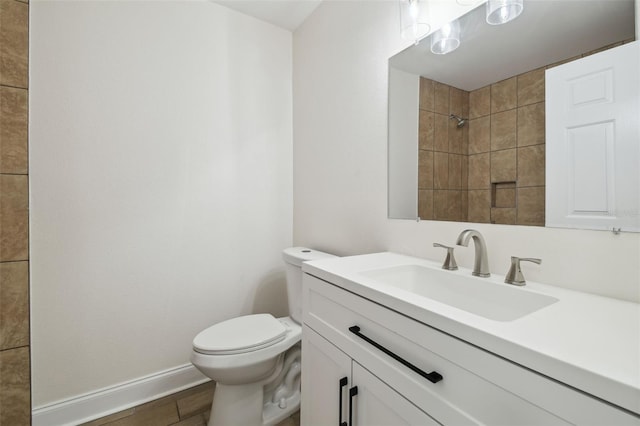 1801 E Navajo Ave, Tampa, FL 33612 - bathroom featuring toilet, vanity, a shower, baseboards, and wood finished floors