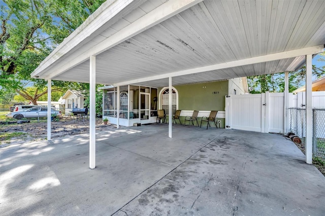 1505 E 99th Ave, Tampa, FL 33612 - view of patio with a gate, a sunroom, a carport, and fence