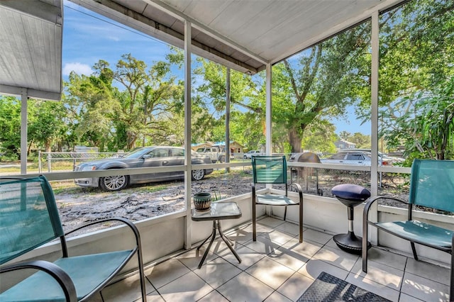 1505 E 99th Ave, Tampa, FL 33612 - sunroom / solarium featuring plenty of natural light and view of wooded area