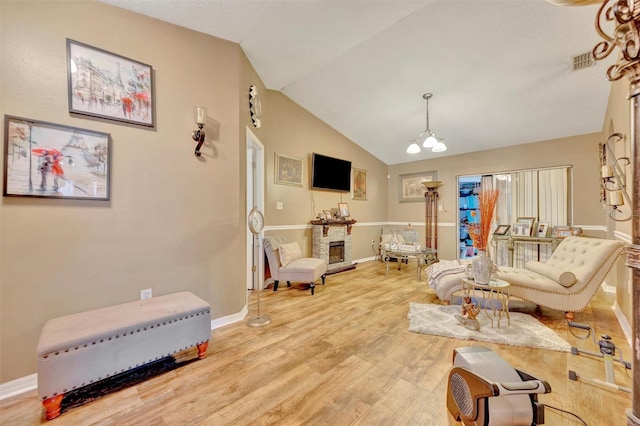 1505 E 99th Ave, Tampa, FL 33612 - living room with light wood-type flooring, lofted ceiling, a chandelier, and baseboards