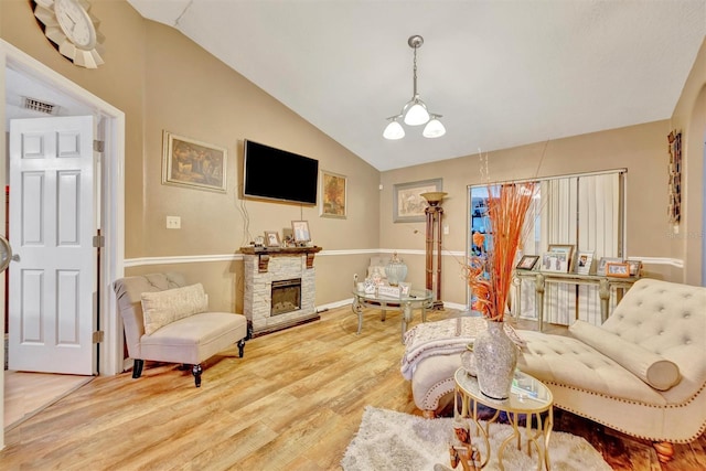 1505 E 99th Ave, Tampa, FL 33612 - living room featuring lofted ceiling, wood finished floors, a fireplace, and baseboards