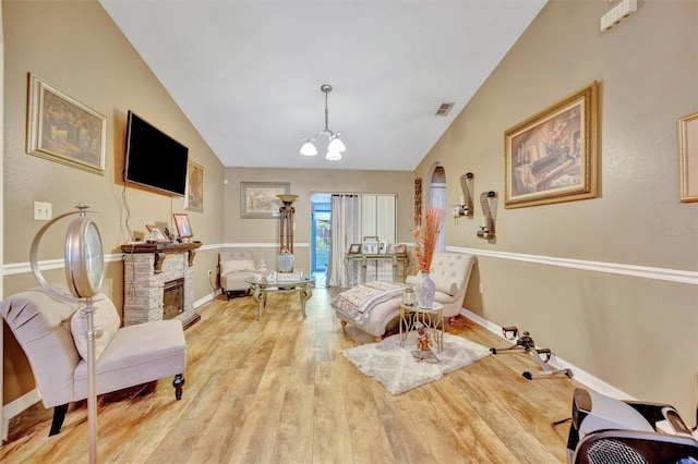 1505 E 99th Ave, Tampa, FL 33612 - living room featuring light wood-type flooring, a chandelier, lofted ceiling, baseboards, and arched walkways