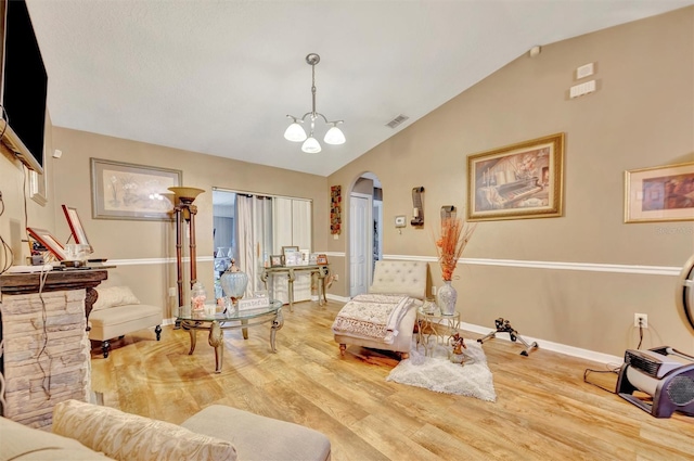 1505 E 99th Ave, Tampa, FL 33612 - living area featuring arched walkways, vaulted ceiling, wood finished floors, and baseboards
