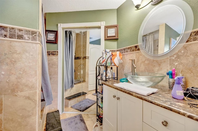 1505 E 99th Ave, Tampa, FL 33612 - bathroom featuring tile walls, a shower with shower curtain, vanity, and a wainscoted wall