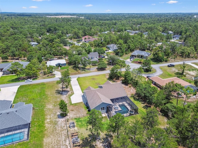 aerial perspective of suburban area featuring a heavily wooded area