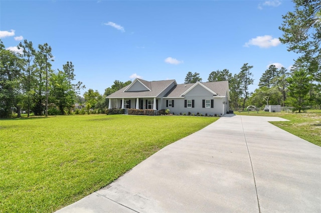 view of front of house with concrete driveway, a front yard, and stucco siding