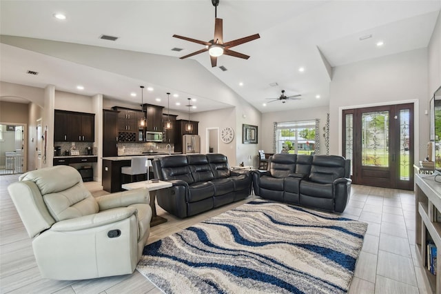 living room with ceiling fan, recessed lighting, arched walkways, and high vaulted ceiling