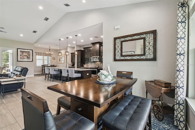 dining area featuring lofted ceiling, recessed lighting, and baseboards