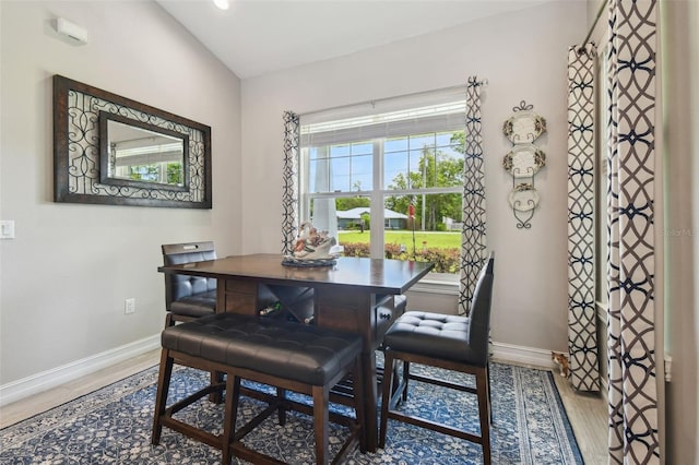 dining room featuring baseboards, wood finished floors, and recessed lighting