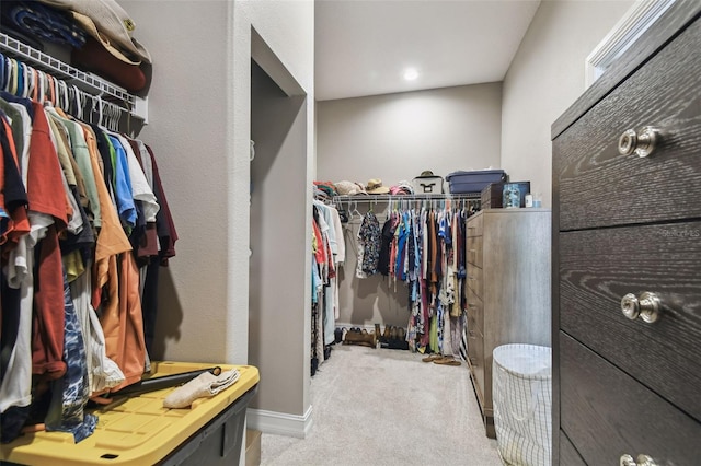 walk in closet featuring carpet flooring
