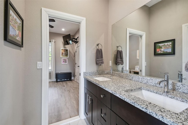 full bath featuring double vanity and wood finished floors