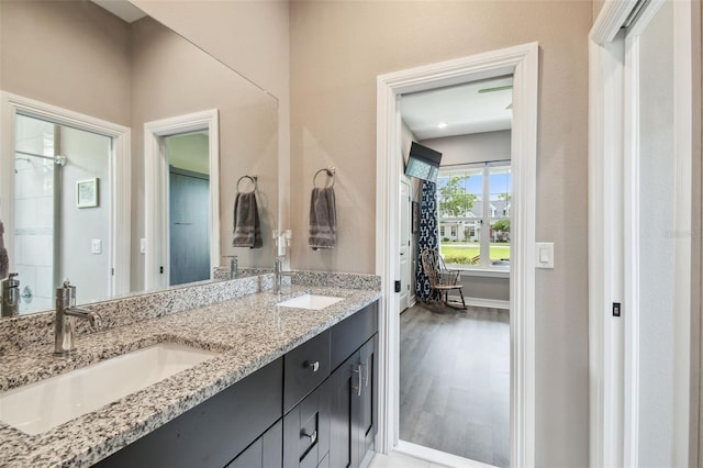 full bath featuring double vanity and wood finished floors