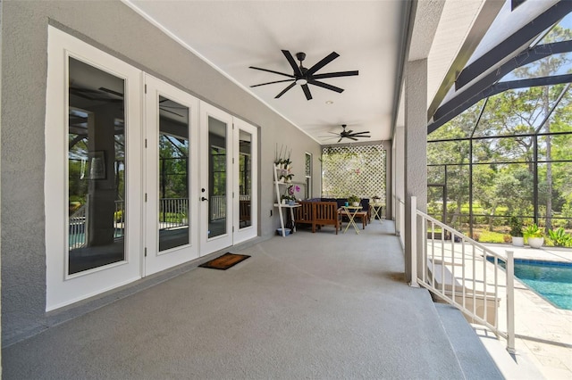 view of patio with french doors, an outdoor pool, and ceiling fan