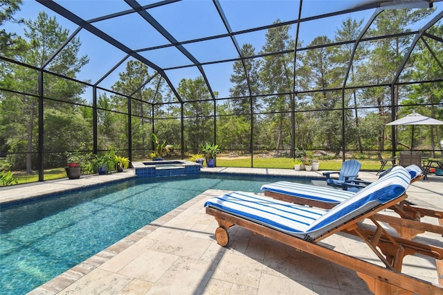 view of swimming pool featuring a patio, a pool with connected hot tub, and a lanai