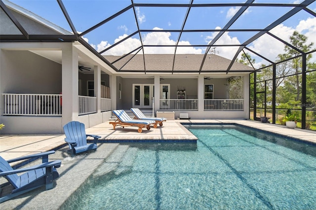 swimming pool featuring ceiling fan, a patio, glass enclosure, and french doors