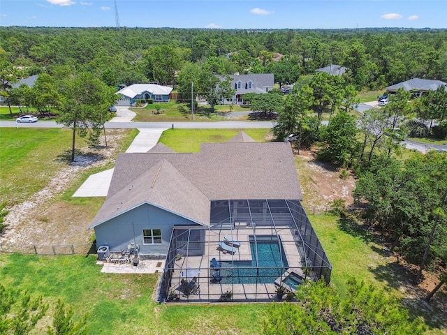 view from above of property with a heavily wooded area