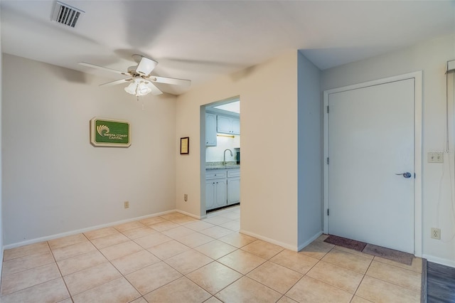 1221 Drew St Unit E12, Clearwater, FL 33755 - empty room with a ceiling fan, light tile patterned flooring, a sink, and baseboards