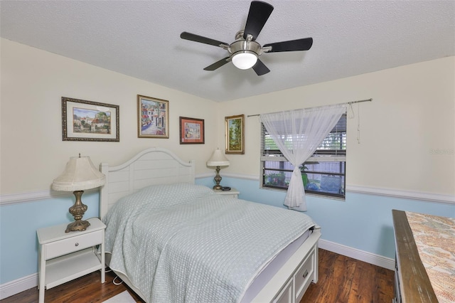 22115 Laver Ln, Land O Lakes, FL 34639 - bedroom featuring dark wood-type flooring, a textured ceiling, a ceiling fan, and baseboards