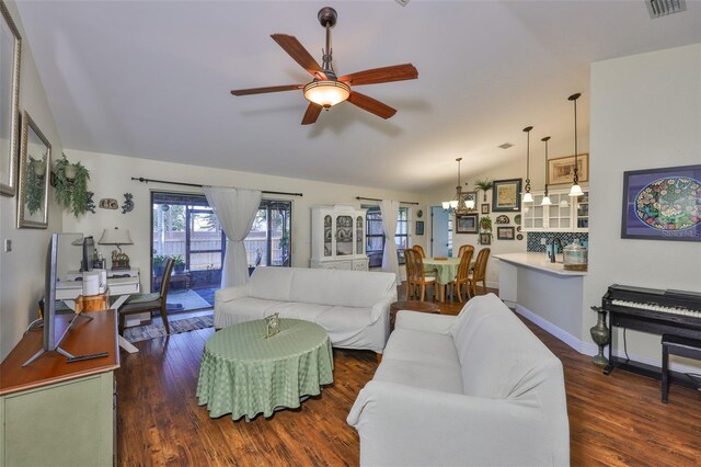 22115 Laver Ln, Land O Lakes, FL 34639 - living area with vaulted ceiling, ceiling fan, wood finished floors, and a chandelier