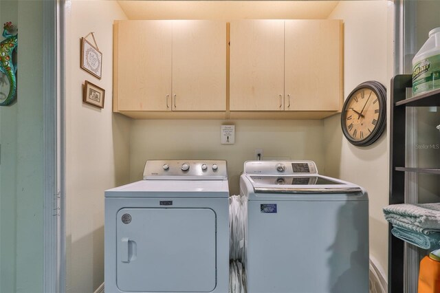 22115 Laver Ln, Land O Lakes, FL 34639 - clothes washing area with washing machine and dryer and cabinet space